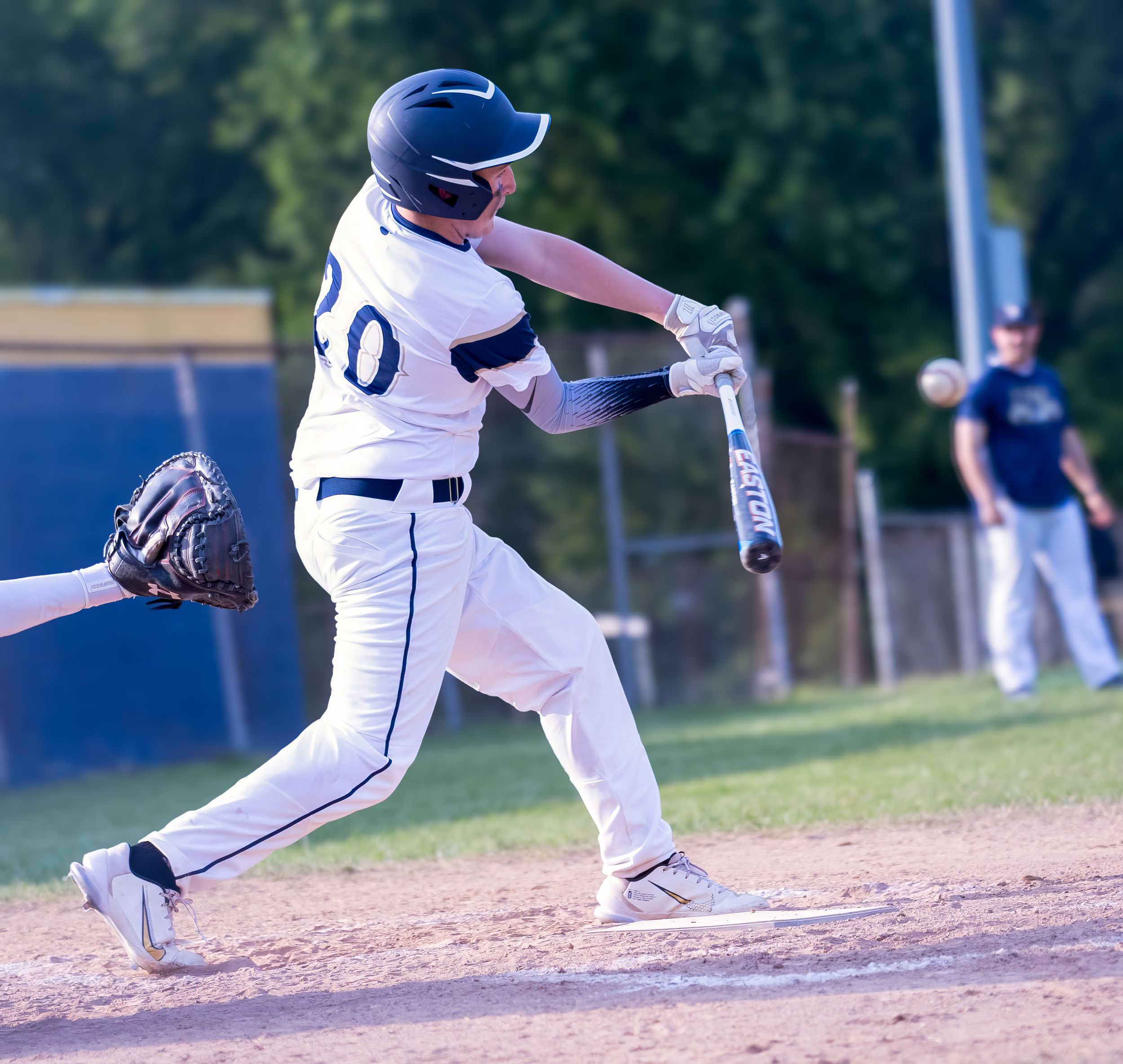 Baseball player in white uniform with number 0 swinging the bat during a game.
Baseball DuPont middle school kanawha county