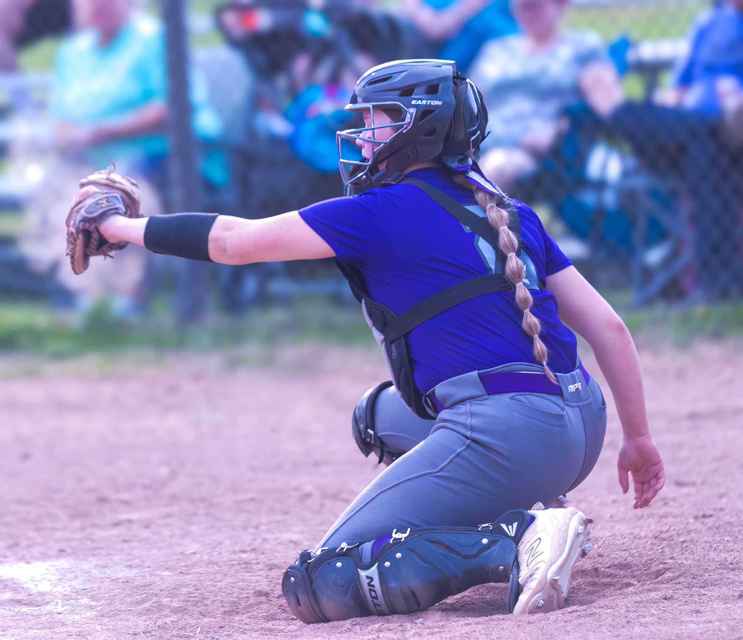 Baseball catcher in blue uniform crouching behind home plate during a game.
Softball riverside high school kanawha county
