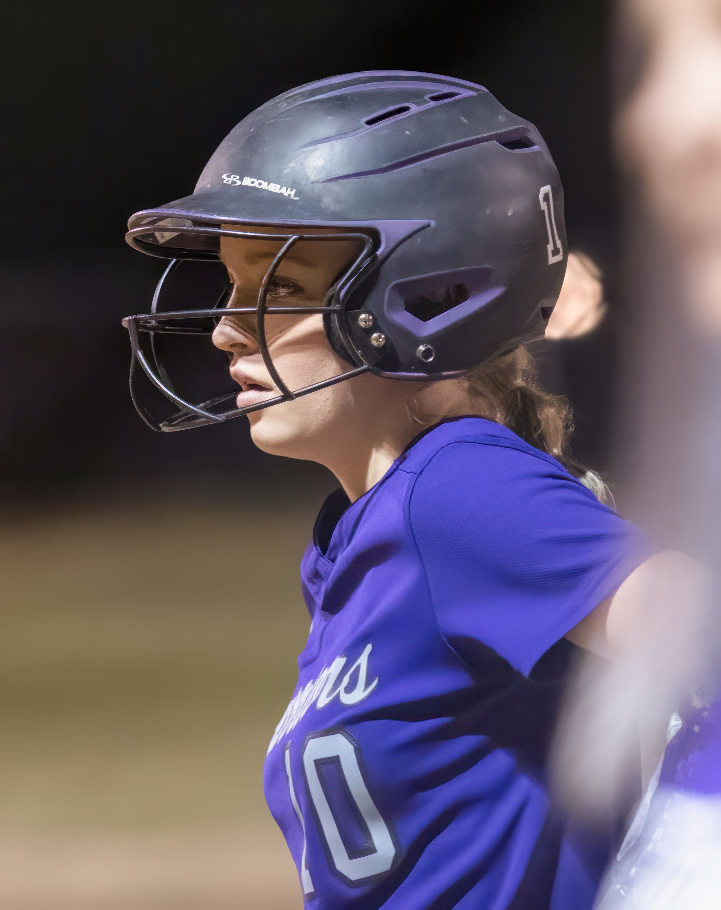 Softball player in purple Warriors uniform wearing batting helmet during game.
Softball riverside high school kanawha county