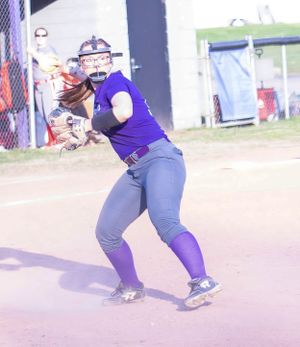 Softball player in purple jersey and gray pants fields a ground ball during a game.
Softball riverside high school kanawha county