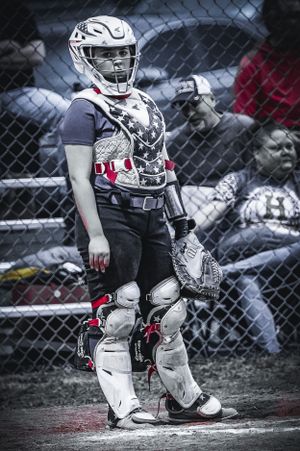 Baseball catcher in protective gear stands ready at home plate in black and white stylized photo.
Softball riverside high school kanawha cou