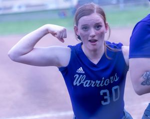 Softball player in blue Warriors jersey points and celebrates during game.
Softball riverside high school kanawha county
