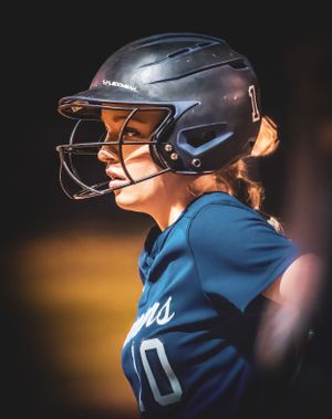 Softball player in navy jersey and batting helmet watches intently during game.
Softball riverside high school kanawha county