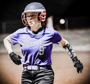 Softball player in purple Warriors uniform steps into batting stance during game.
Softball riverside high school kanawha county