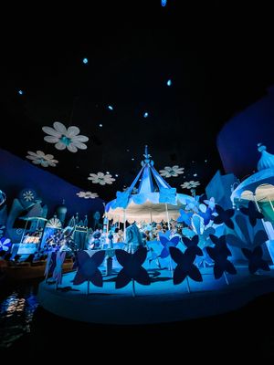 Blue-lit indoor display featuring small illuminated structures and decorative elements creating a magical winter wonderland scene.