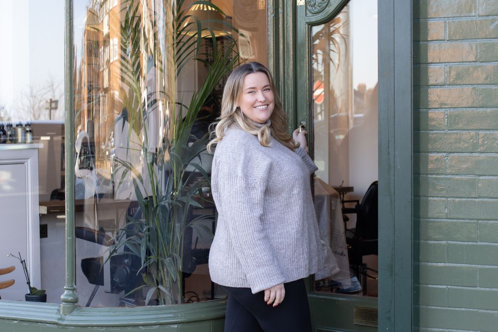 Exterior storefront shots with green painted brick and window displays.