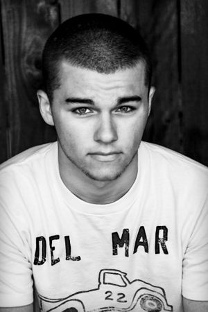 Black and white portrait of young person wearing Del Mar t-shirt.