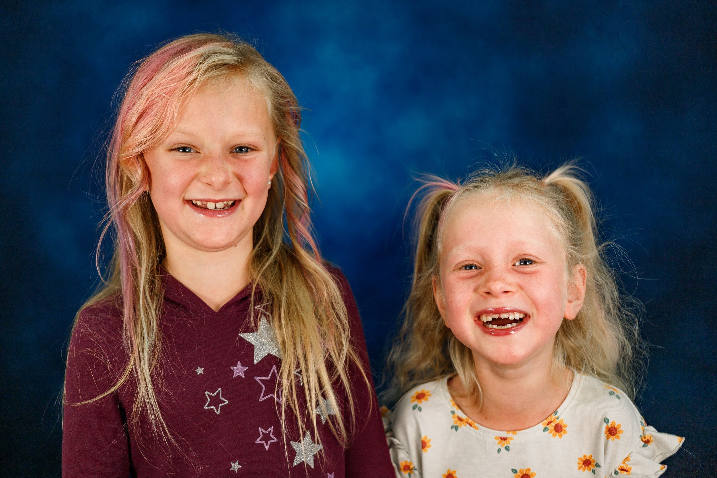 A series of candid childhood portraits showing genuine expressions and laughter against a dark blue background.