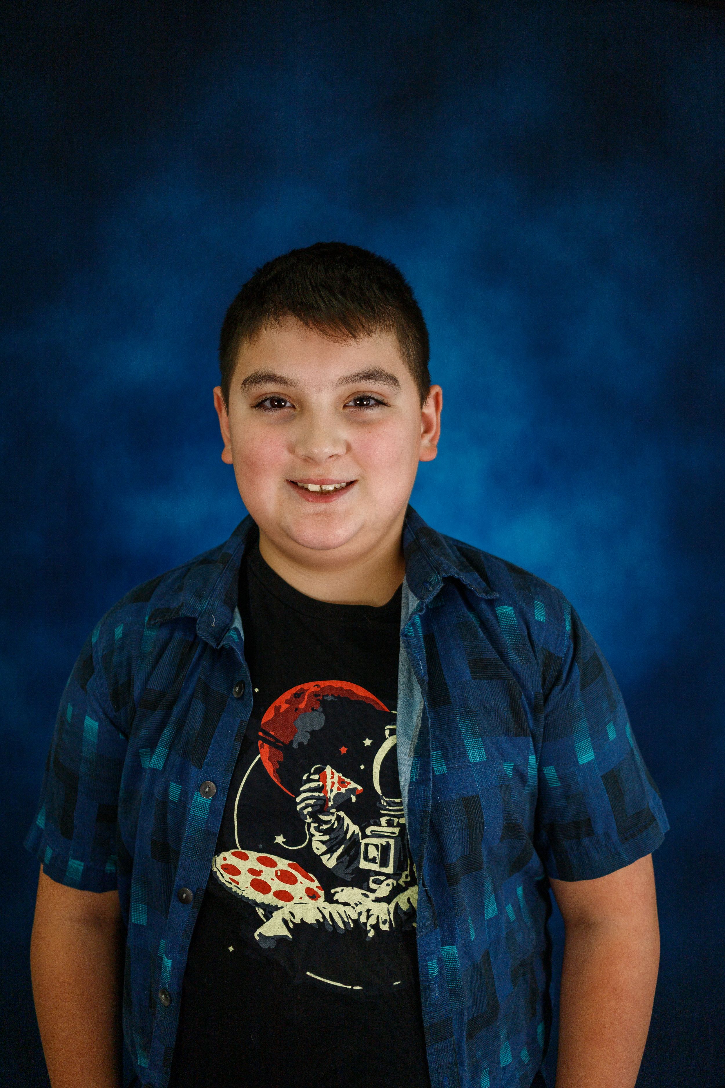 Portrait series against blue backdrop showing casual t-shirt and natural expressions.