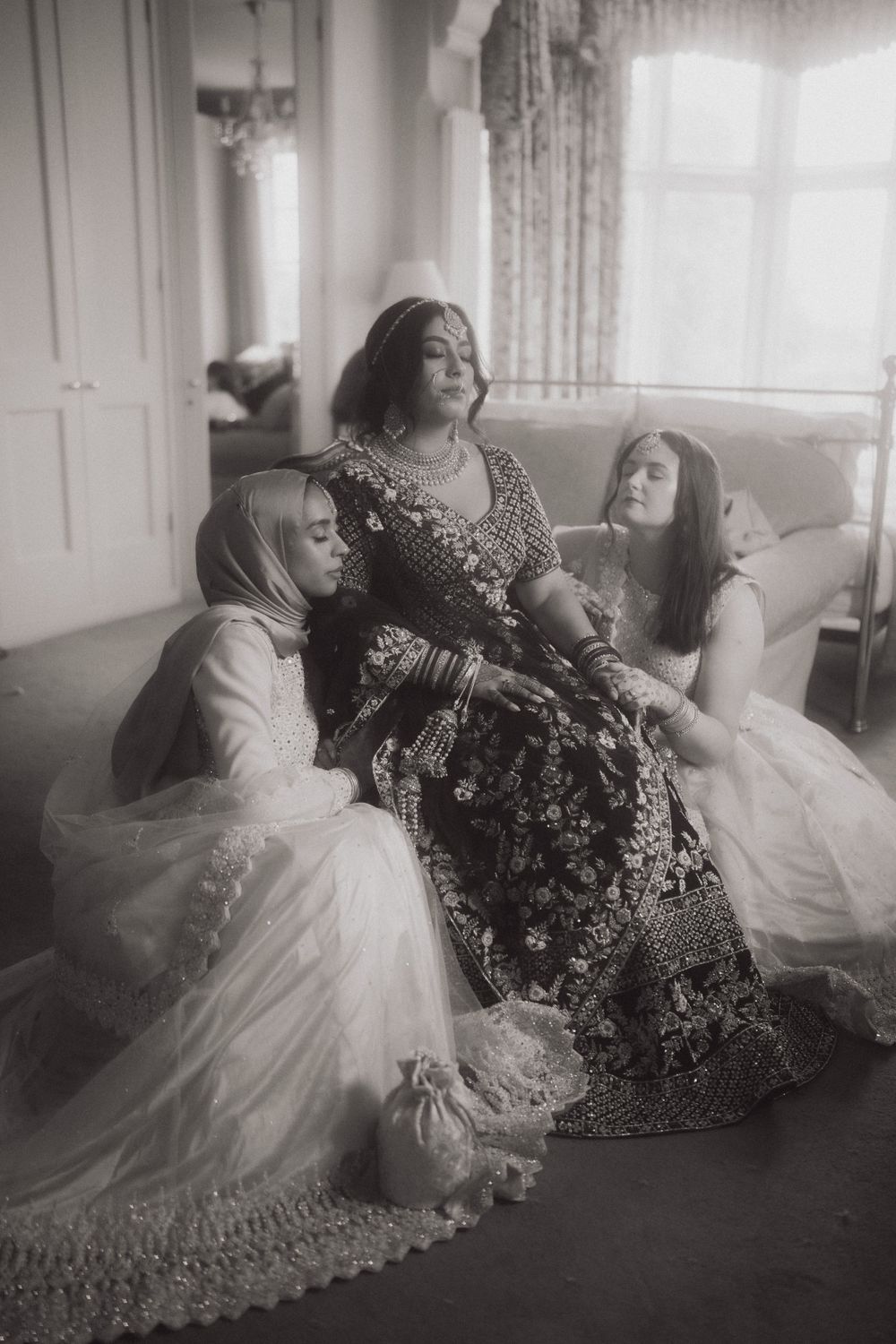 Vintage-style black and white photograph of wedding party in traditional attire.