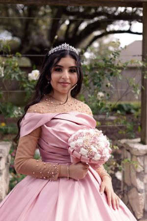 Sweet sixteen outdoor session/portrait of model holding pink bouquet in her lovely pink dress.