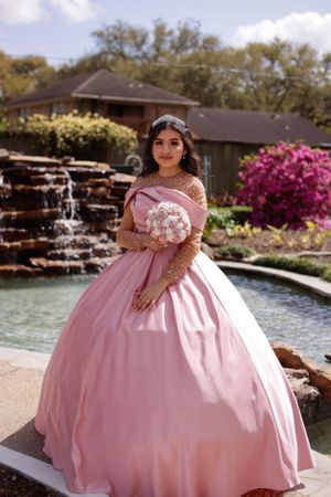 sweet sixteen outdoor portrait standing in front of a water cascade.