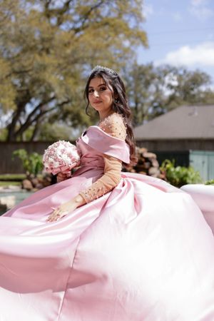 Sweet sixteen outdoor session/portrait of model sitting doing a half side picture.