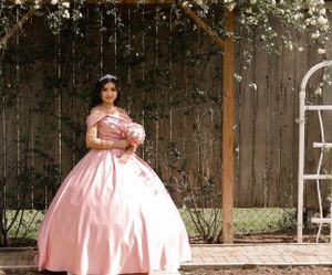 Sweet sixteen outdoor session/portrait of model standing in front of wooden fence.
