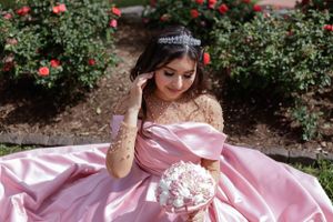 Sweet sixteen outdoor session/portrait of model in the ground to show background and bouquet.