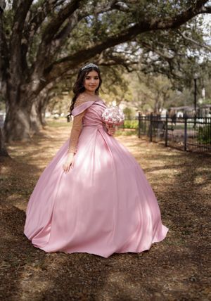 Sweet sixteen in her beautiful gown taking some stunning portrait outdoors under a canopy of trees.