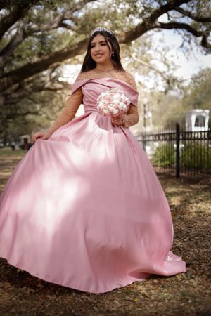 Sweet sixteen outdoor session/portrait model is swaying her dress under the canopy of trees.