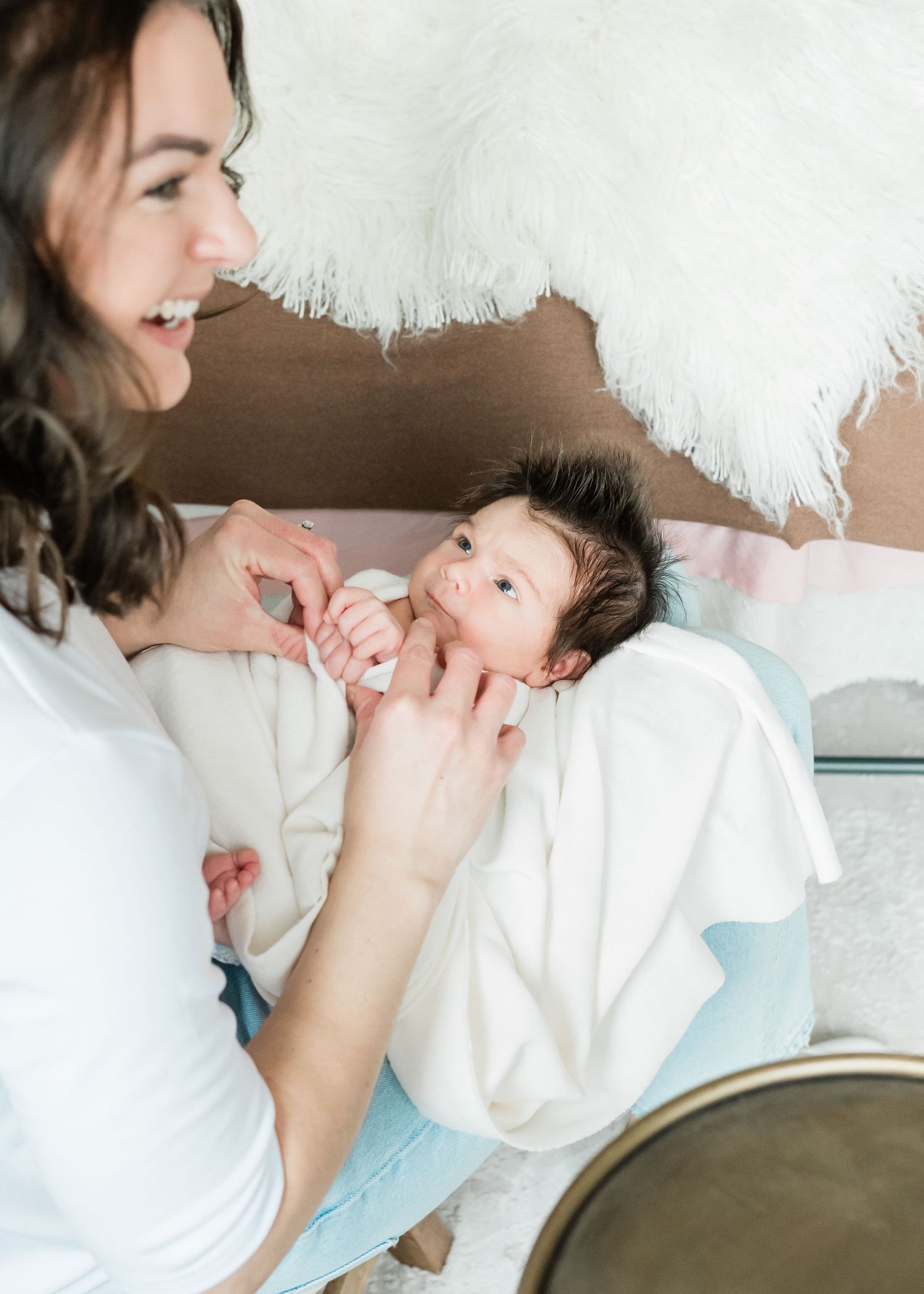A tender moment captured between photographer and small newborn.