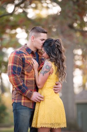 Romantic fall couples portrait surrounded by golden and red autumn foliage, captured by Rafferty & Grace Portraiture. 
Secrest Arboretum