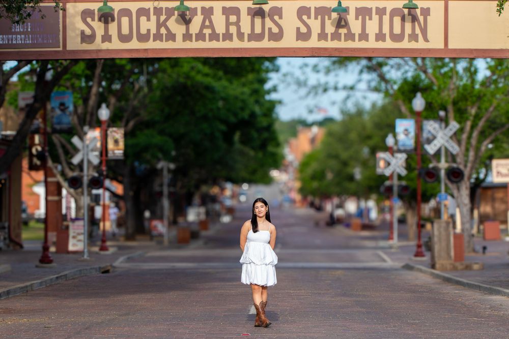 Historic Stockyards Station sign and street view in Fort Worth, Texas.