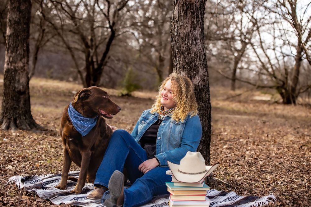 Couple relaxing on blanket during outdoor autumn photoshoot.