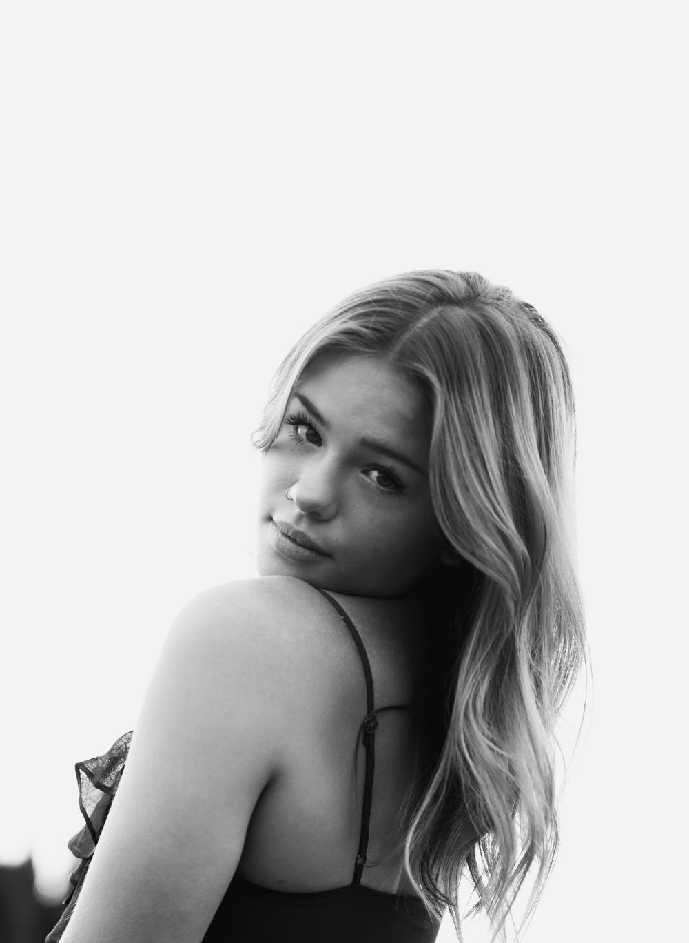 Black and white artistic portrait series showing a blonde woman posing in dramatic lighting.