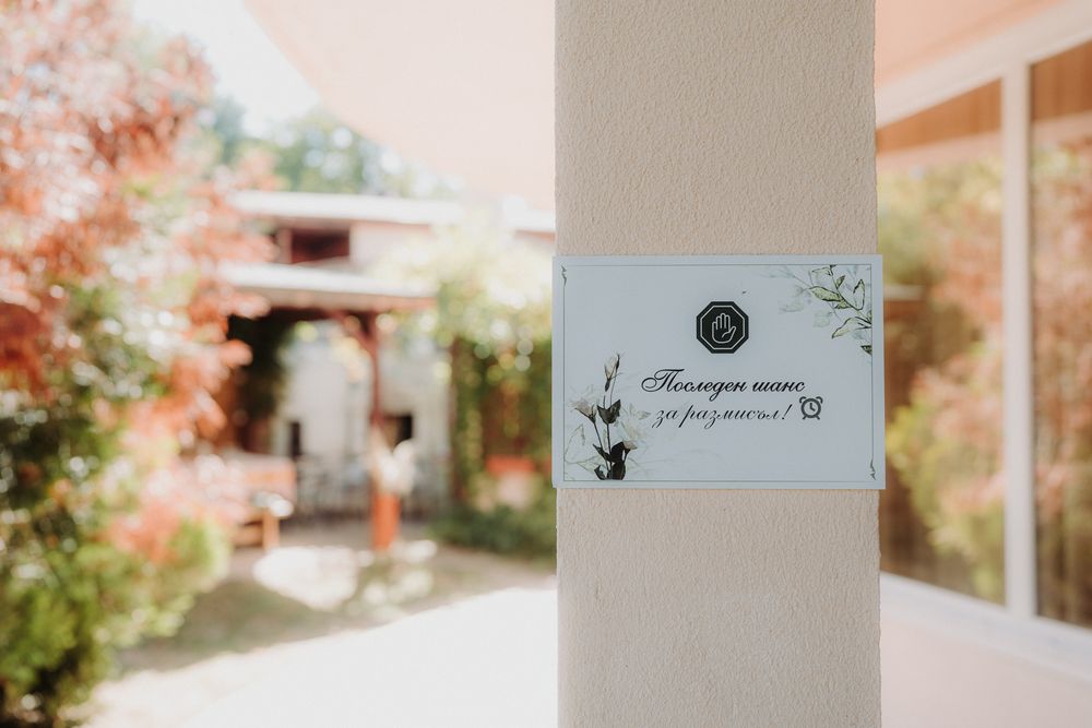 Elegant wedding venue details with handwritten place cards and decorative elements in a rustic setting.
