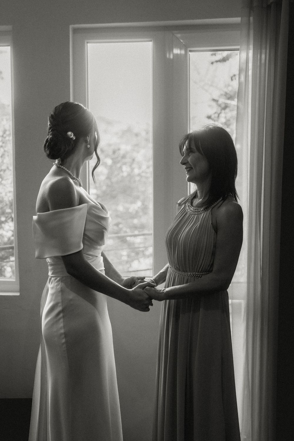 Silhouettes of people getting ready by window with natural light streaming in.