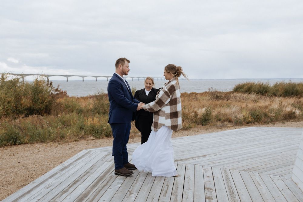 Bride and groom exchange vows during maritime wedding ceremony in New Brunswick, fall October wedding photography Confederation Bridge PEI