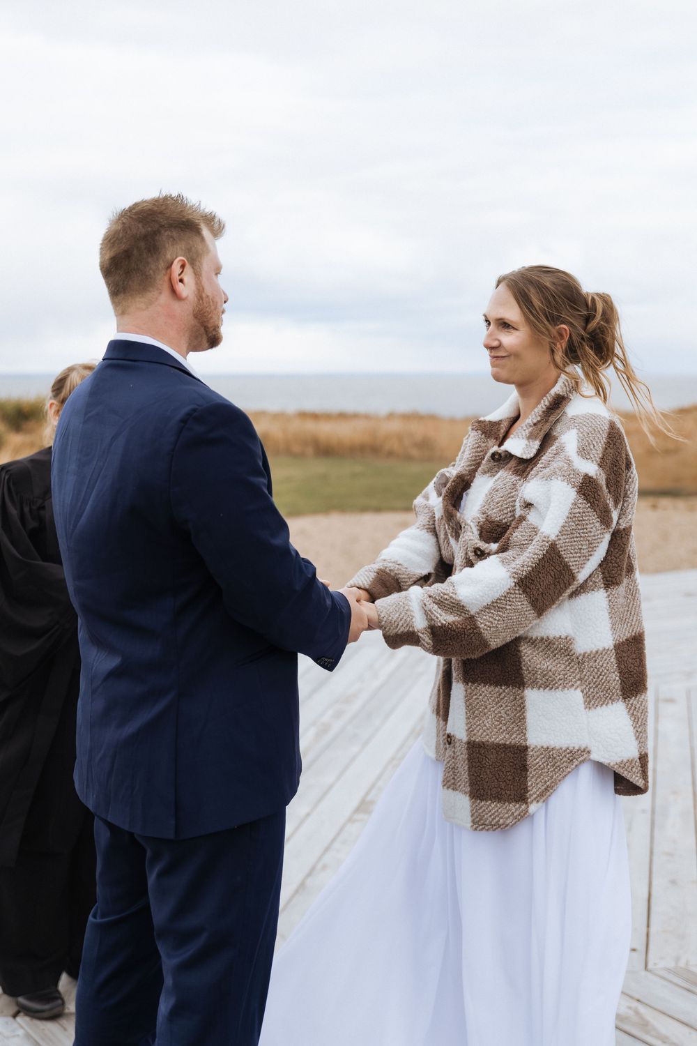 Bride and groom exchange vows during maritime wedding ceremony in New Brunswick, fall October wedding photography Confederation Bridge PEI