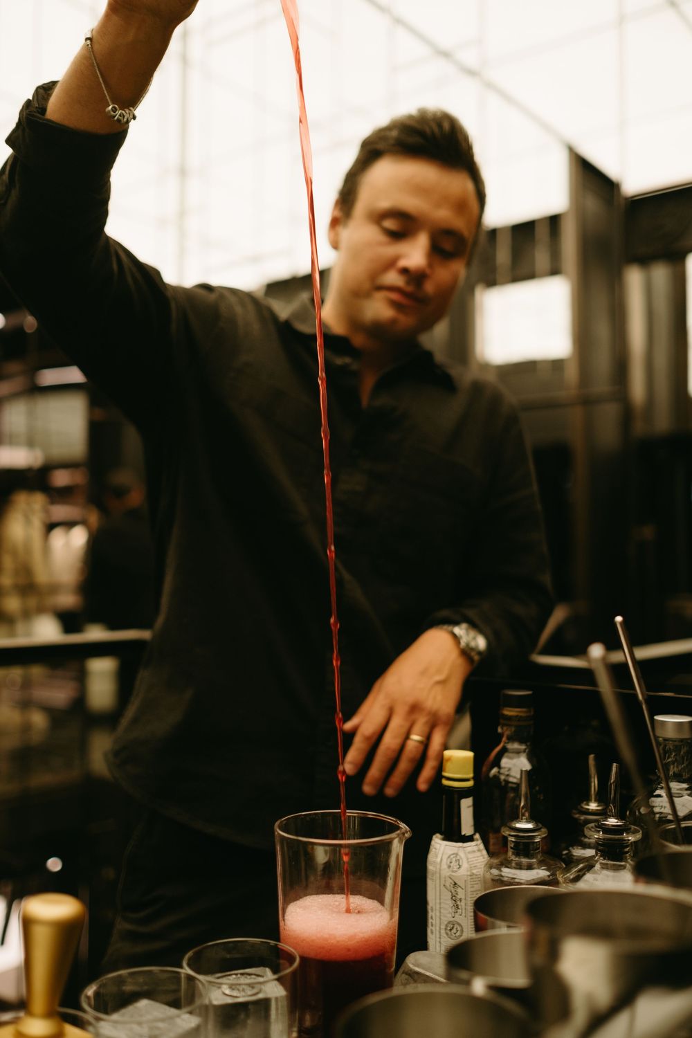 bartender pouring a drink at Moncler store during VIP event while being captured by experienced event photographer in Stockholm