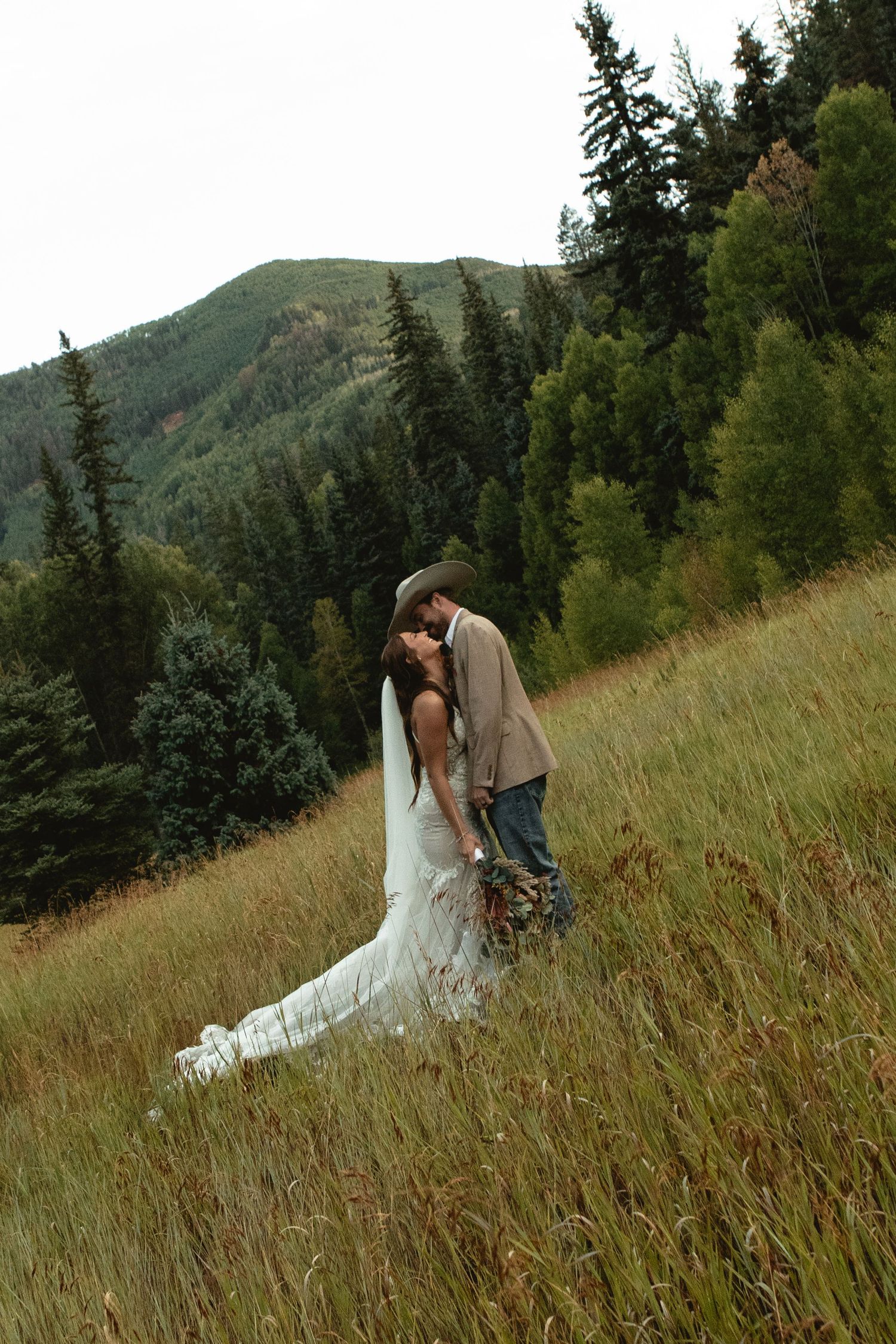 Bride cuddles in for a tender kiss