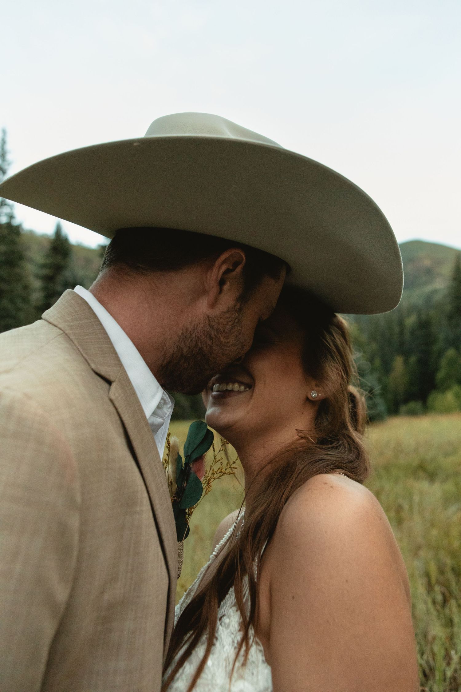 flirting with bride under cowboy hat