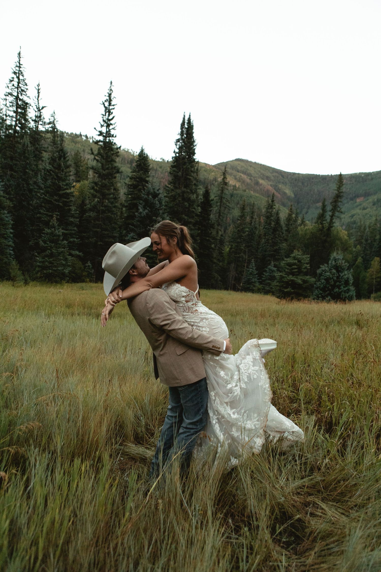 Groom lifts bride celebrating marriage