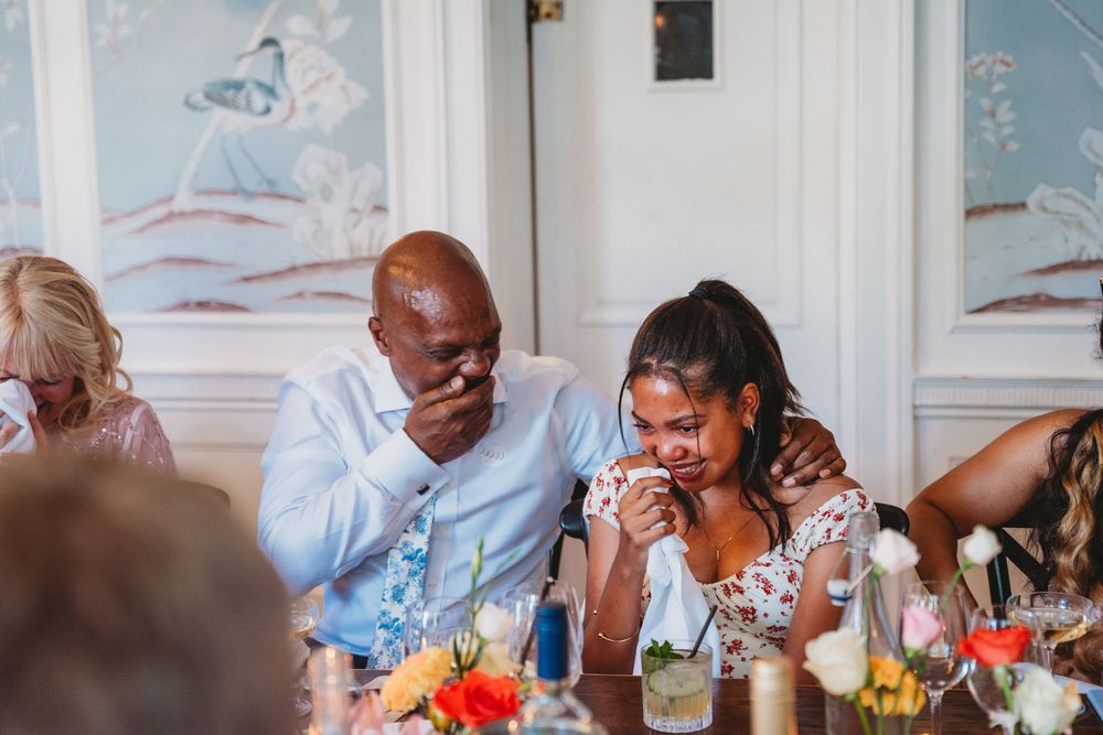Wedding guests enjoying conversation during reception dinner.