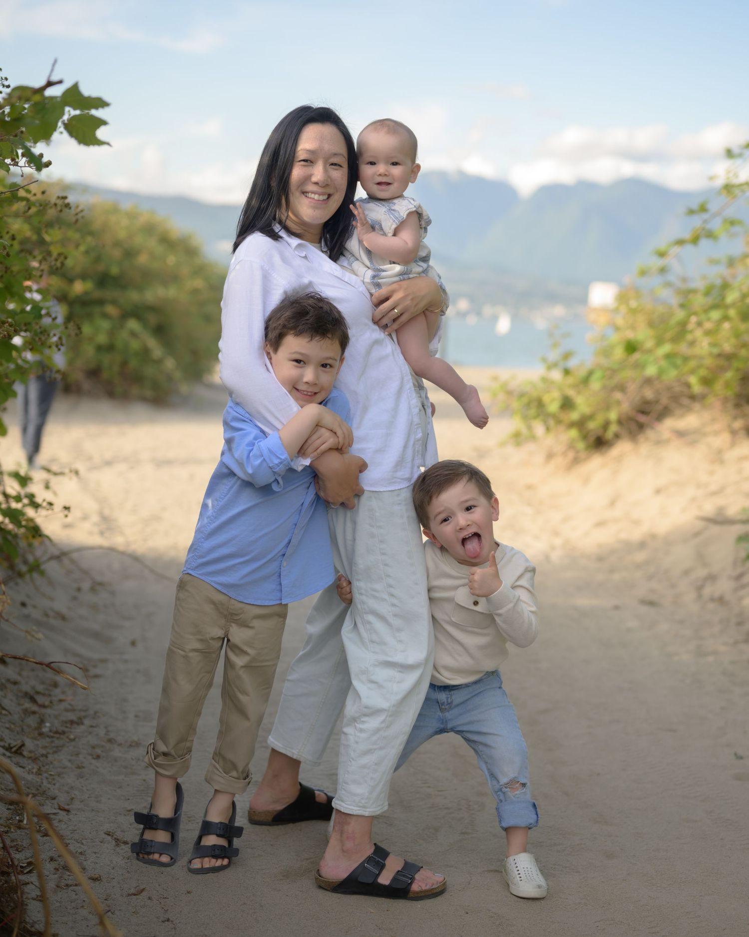 Fun Family portrait session at The Shipyards, North Vancouver, mom and dad holding child upside down laughing