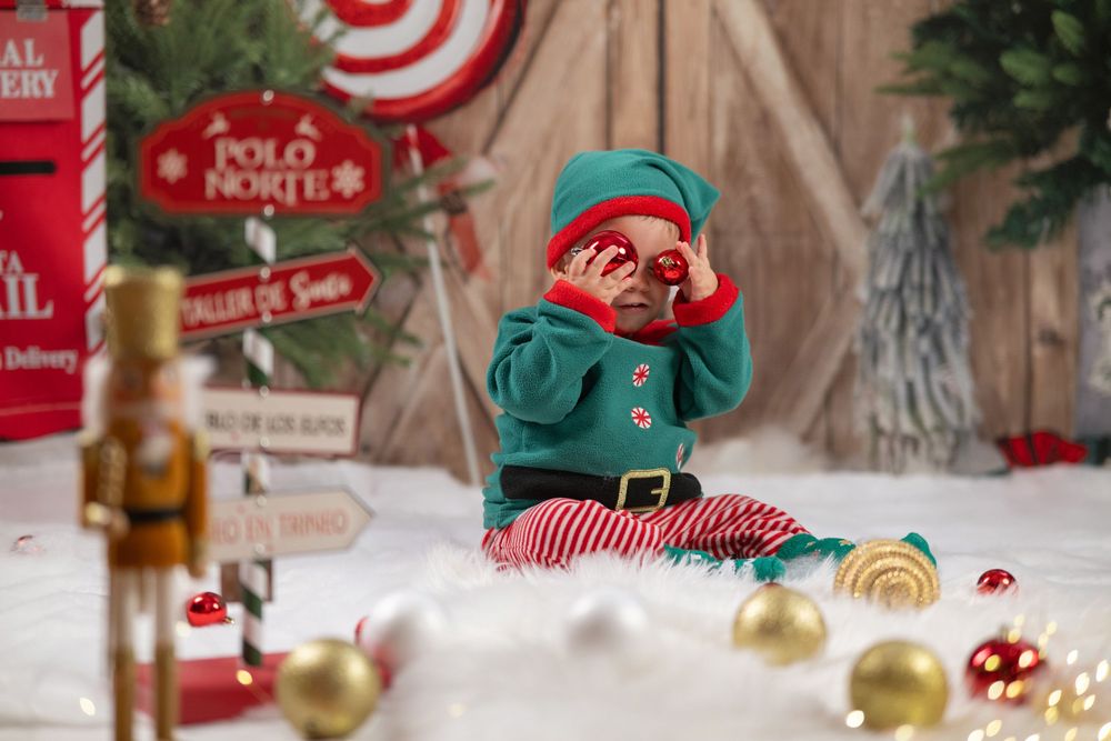 A festive holiday bar setup with red and white decorations, candy canes, and Christmas ornaments on a snowy display.