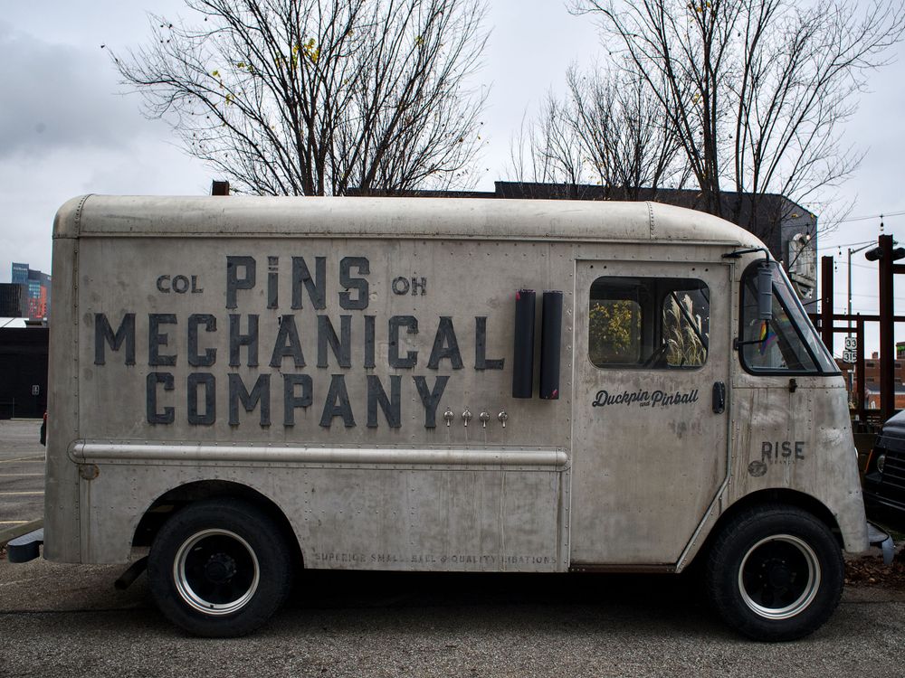 A vintage delivery van with 'Pine Mechanical Company' text on its weathered white exterior.