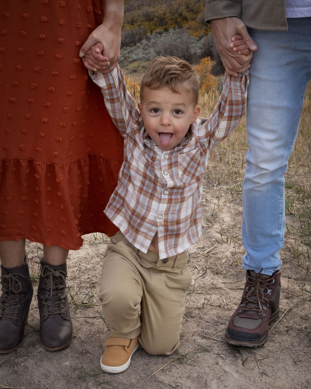 A series of photos showing a child's feet and legs in khaki pants and plaid shirt alongside adult legs against a red wall.