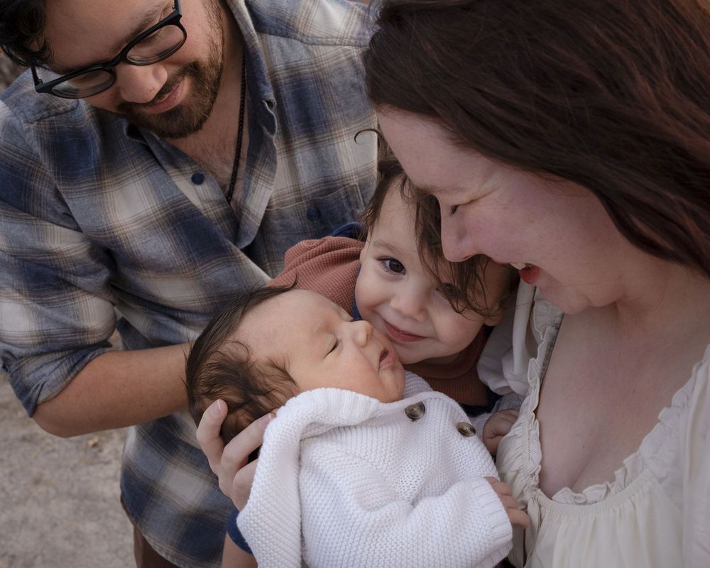 A series of intimate family moments showing parents lovingly holding and kissing their newborn baby.