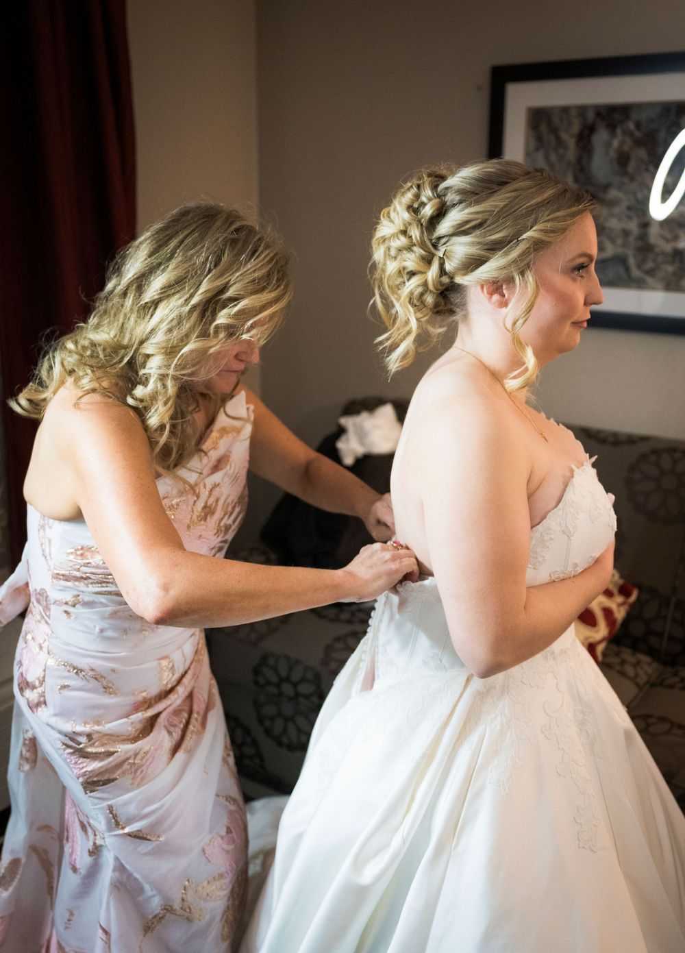 Series of photos showing the process of a bride getting into her wedding dress.