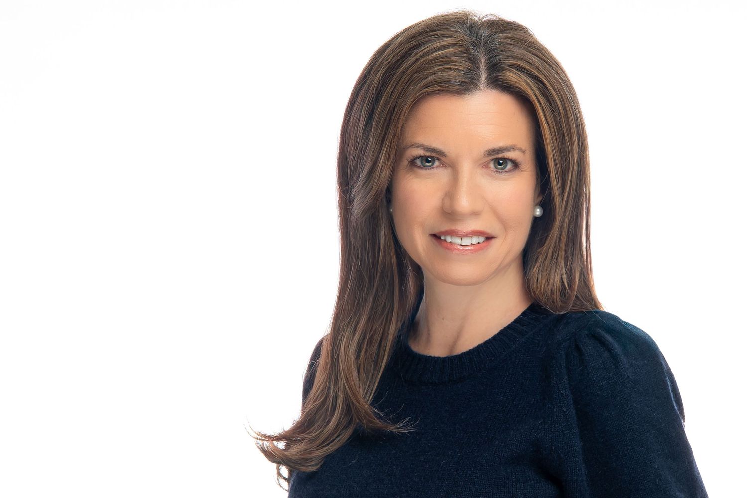 Professional headshot portraits of a woman with brown hair wearing a black top against a white background.
