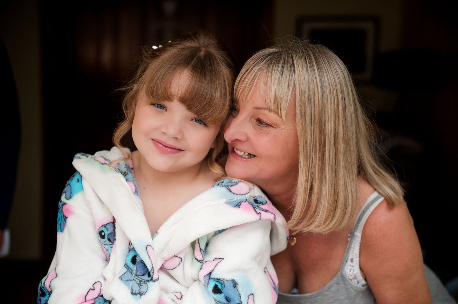 A heartwarming moment between a mother and daughter as they share a close embrace while wearing floral prints.