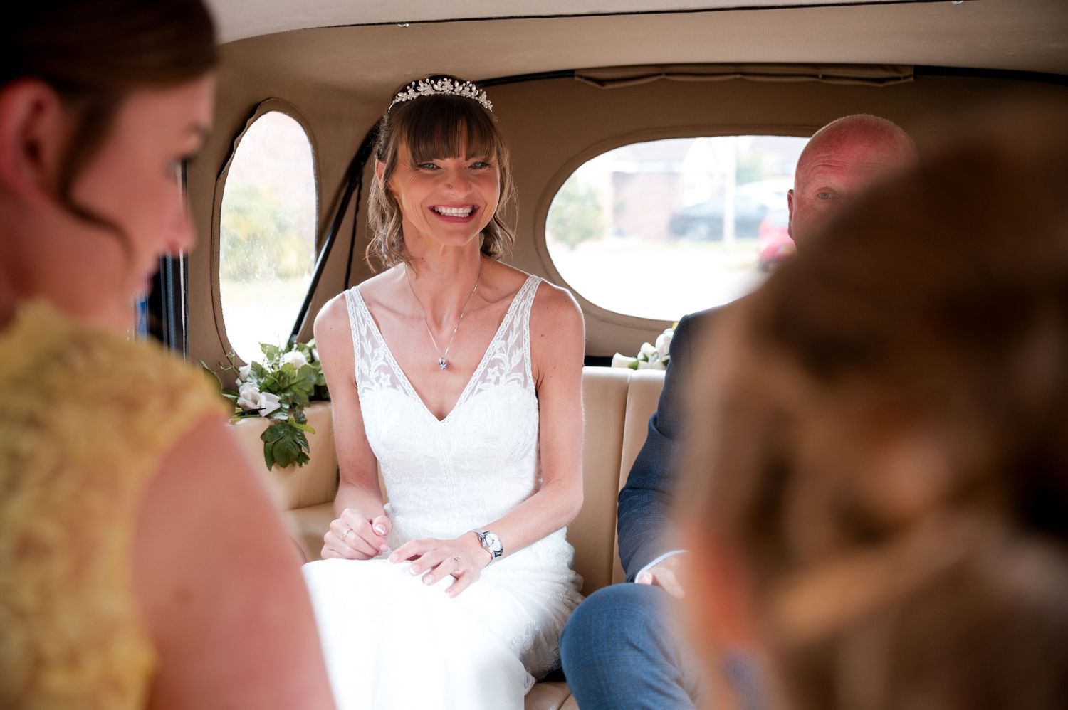 A bride and groom share an intimate moment during their wedding ceremony at a rustic venue.