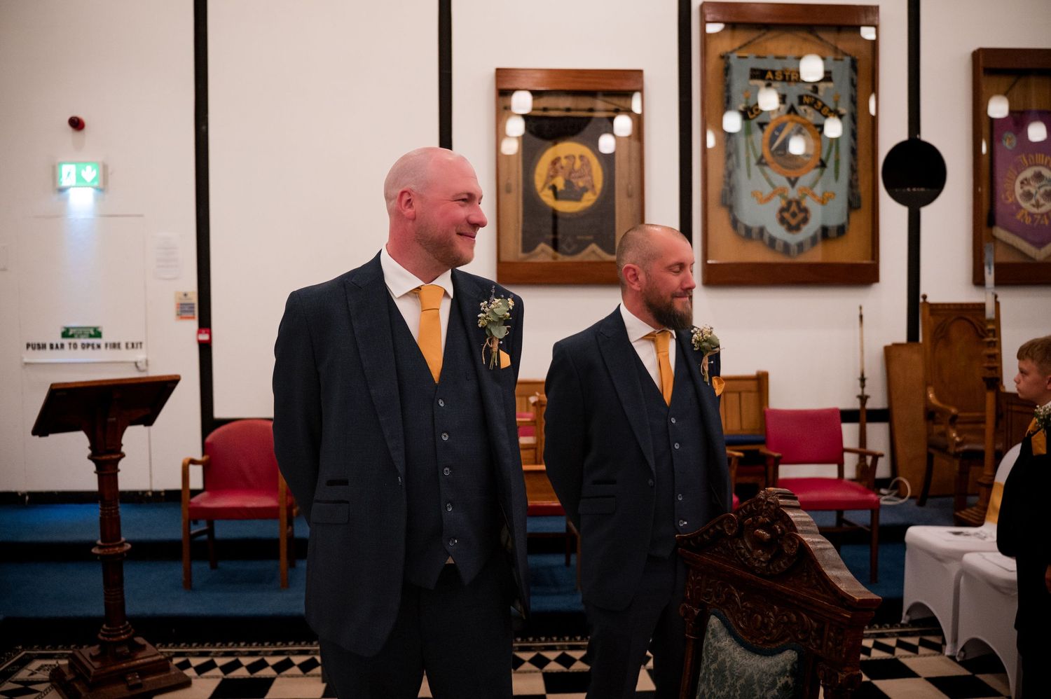 A row of wedding guests seated in a church sanctuary during a formal ceremony.