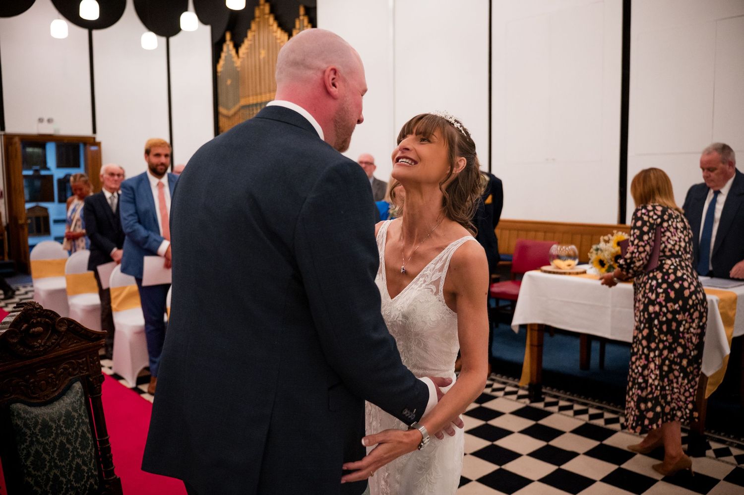 A series of black and white checkered floor tiles visible in multiple wedding reception photographs.