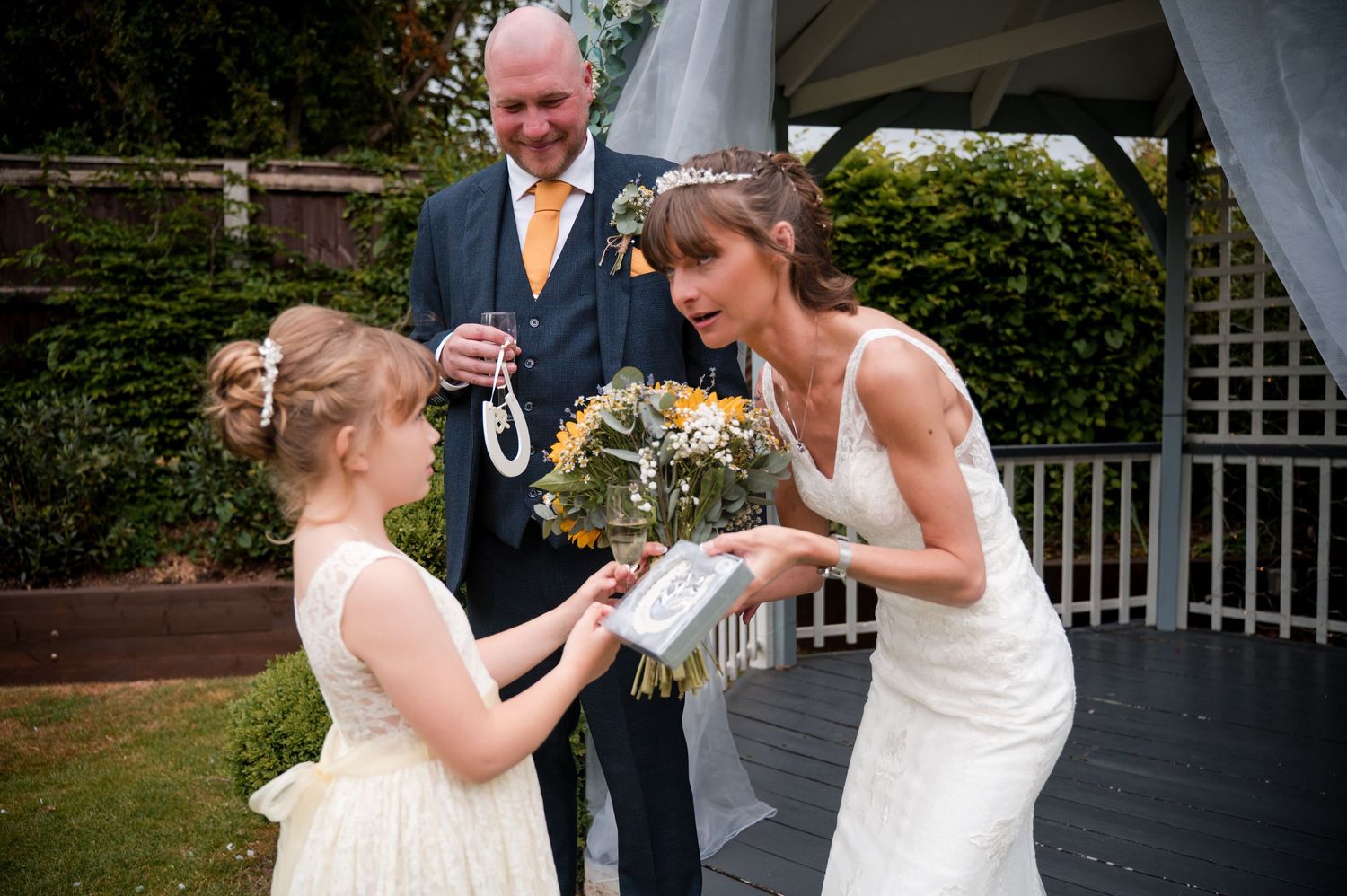 A series of candid wedding photos showing tender moments between a couple during their outdoor garden ceremony.