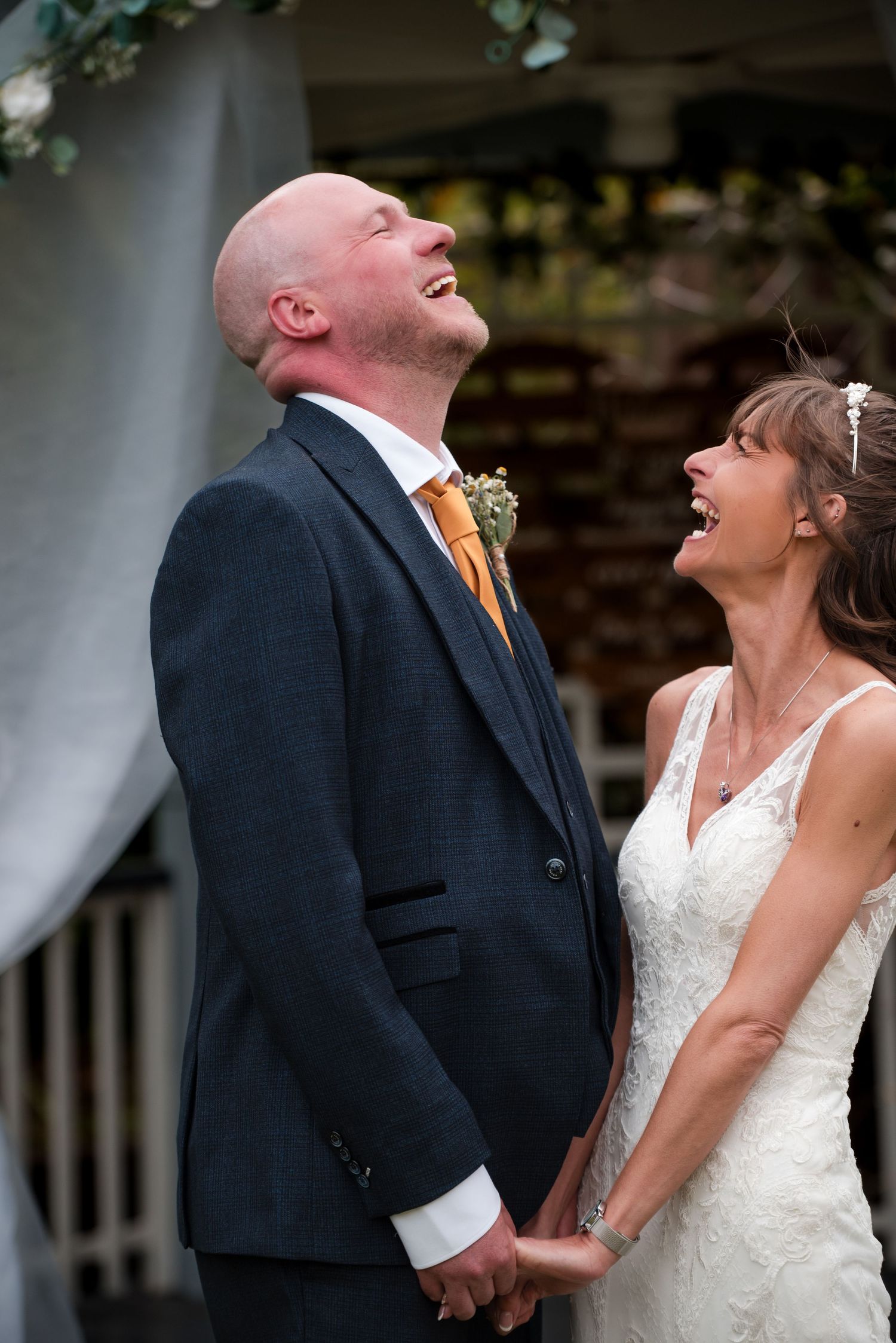 A joyful wedding moment captured in sequence showing a couple laughing together outdoors in formal attire.