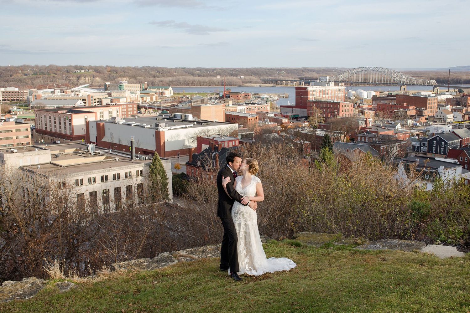 Dubuque, Iowa skyline and city view of the Mississippi River. Bride and Groom on a spring wedding day.