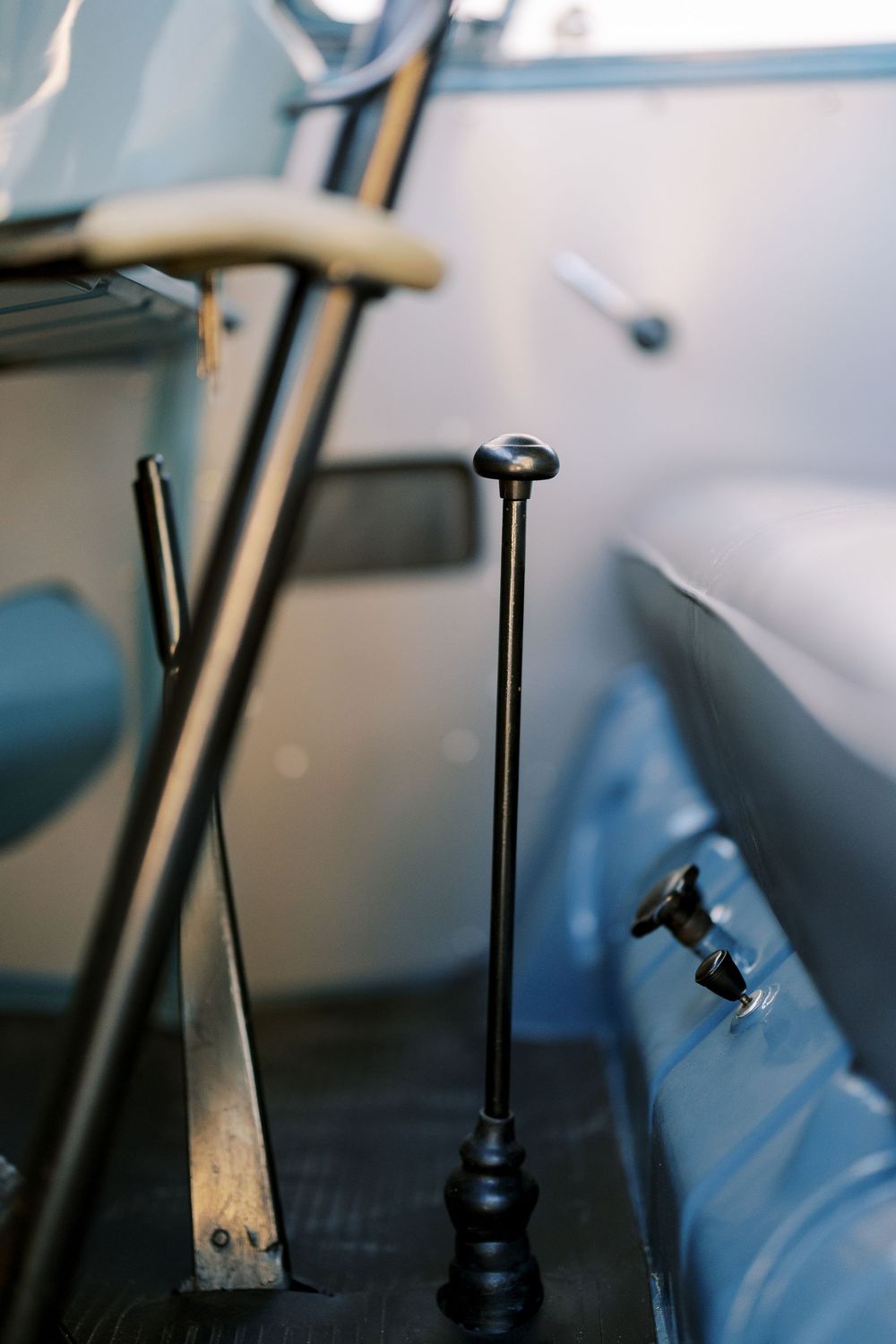 Close-up shots of black gear shift levers in a vintage Volkswagen vehicle.